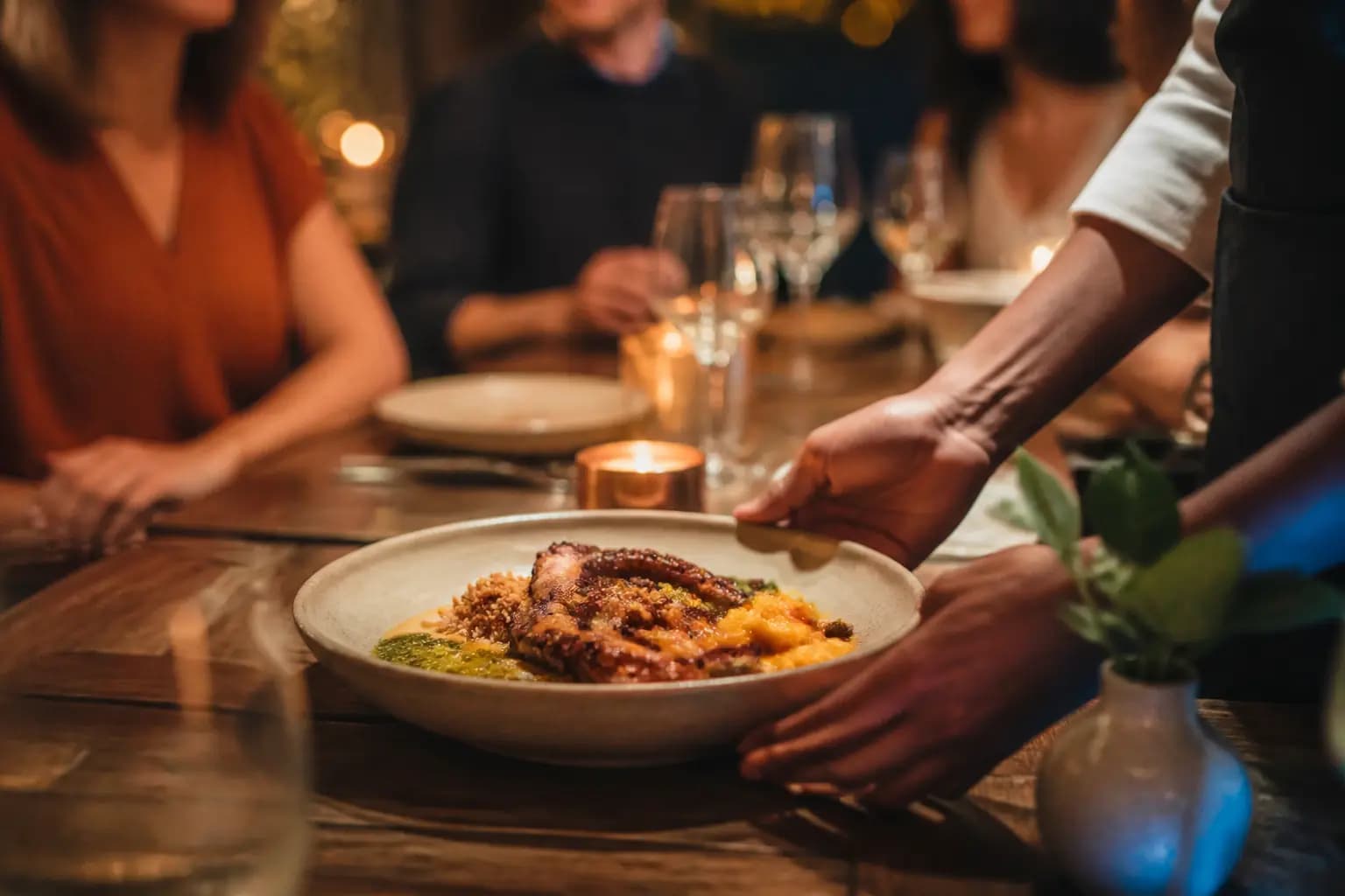A plate being served at a restaurant table.